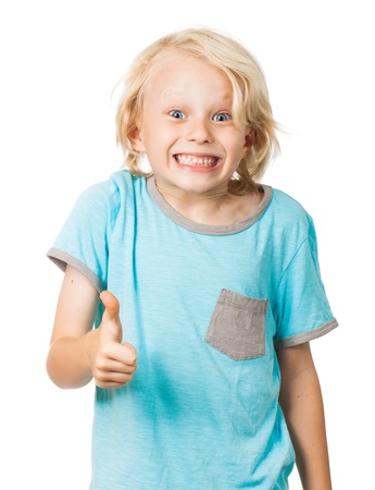 A cute young and very happy and positive boy smiles and gives thumbs up   Isolated on white の写真素材