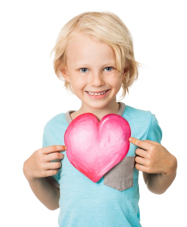 Portrait of a very cute young boy smiling and holding out a love heart  Isolated on white の写真素材