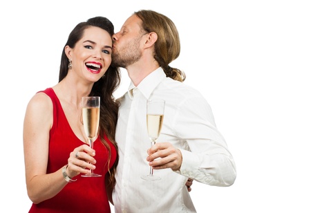 A man giving a woman a kiss on the cheek while having some champagne  Isolated on white の写真素材