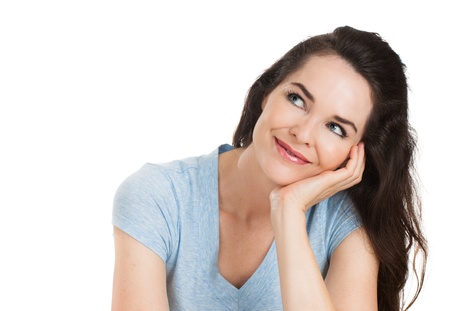 A close-up portrait of a beautiful woman deep in thought looking at copy-space   Isolated on white の写真素材