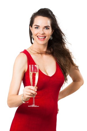 A beautiful happy woman wearing a red dress holding a glass of Champagne and looking at camera  Isolated on white の写真素材