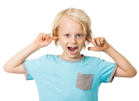A cute cheeky young boy smiling and sticking his fingers in his ears  Isolated over white 
