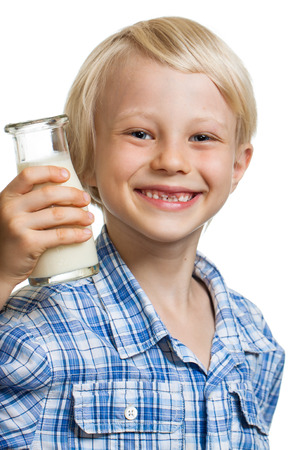 Happy cute boy with a bottle of milk  Isolated on white の写真素材