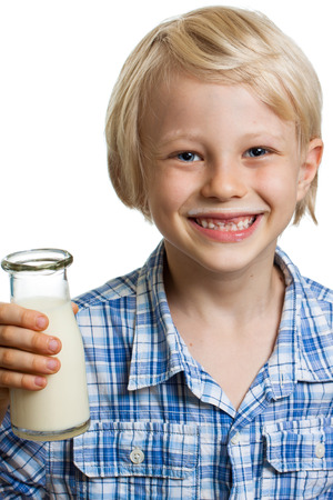 Close-up of a happy cute boy with milk moustache and bottle of milk  Isolated on white の写真素材