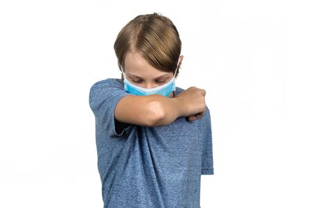 Young teenage boy wearing a protective mask coughing. Isolated on white.の写真素材