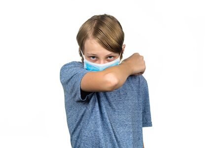 Young teenage boy wearing a protective mask coughing. Isolated on white.の写真素材