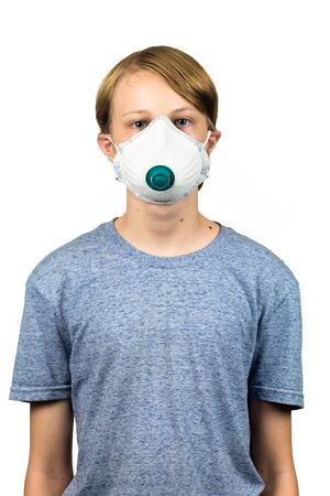 Young teenage boy wearing a protective mask to protect against virus infection.  Isolated on white.の写真素材
