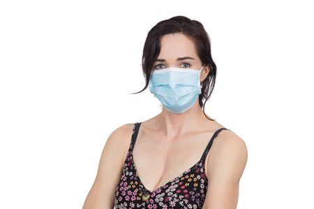Woman wearing protective face mask to protect against virus infection. Isolated on white.の写真素材