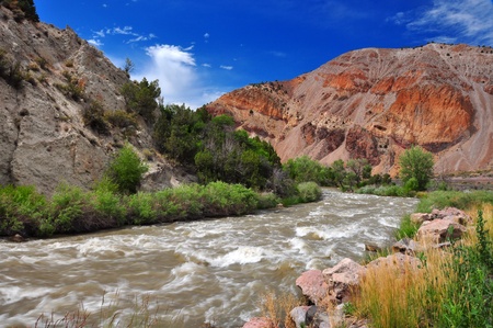 A fast flowing stream in utah with mountains in the backgroundの写真素材