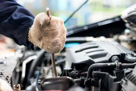 Close up, People are repair a car Use a wrench and a screwdriver to work.