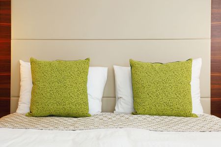 hotel bedroom with green pillowの写真素材