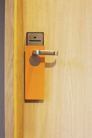 hotel door with orange card to avoid disturbingの写真素材
