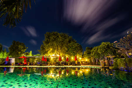 big pool at night in a holiday resort in thailandの写真素材