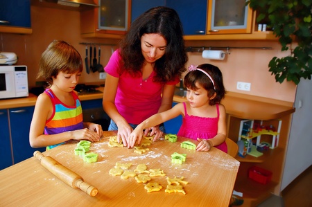 Mother and two daughters baking together