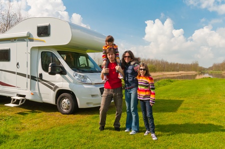 Family vacation in camping  Happy active parents with kids travel on camper  Family having fun near their motorhome  Spring vacation trip with children の写真素材