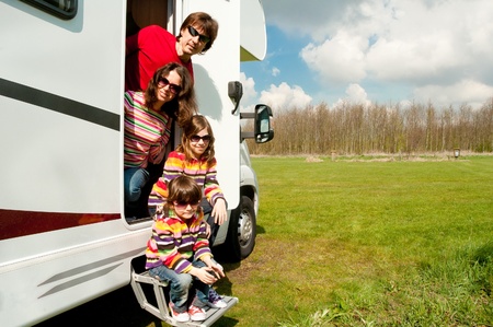Family vacation in camping  Happy active parents with kids travel on camper  Family having fun near...