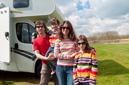 Family vacation in camping  Happy active parents with kids travel on camper  Family having fun near their motorhome  Spring vacation trip with children の写真素材