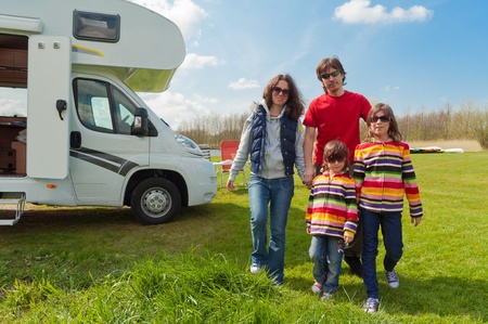 Family vacation in camping  Happy active parents with kids travel on camper  Family having fun near their motorhome  Spring vacation trip with children の写真素材