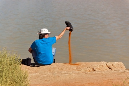 African desert adventure  Active man relaxing after hiking sand dunes of Namib desert  Tourism and adventure conceptの写真素材