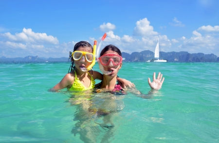 Happy mother and kid snorkeling in tropical sea, family beach vacationの写真素材