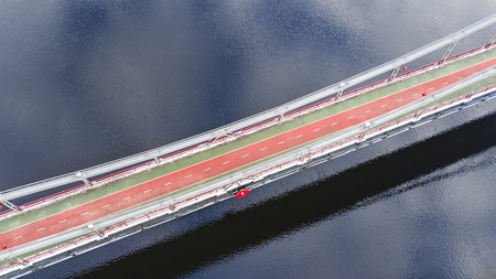 Aerial top view of pedestrian and cycling path lane on Park bridge in winter and Dnieper river from above, city of Kyiv (Kiev), Ukraineの写真素材