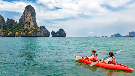 Family kayaking, mother and daughter paddling in kayak on tropical sea canoe tour near islands, having fun, active vacation with children in Thailand, Krabiの写真素材