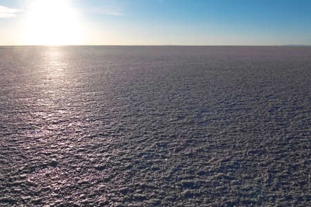 Landscape of Salar de Uyuni in Bolivia covered with water, salt flat desert and sky reflections