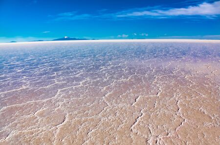 Landscape of Salar de Uyuni in Bolivia covered with water, salt flat desert and sky reflectionsの写真素材