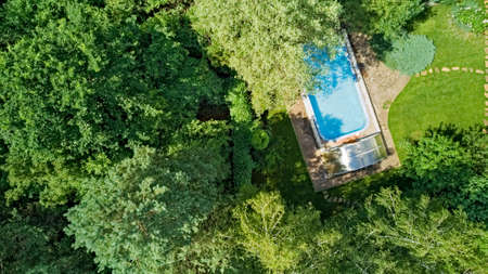 Aerial top view of swimming pool in beautiful gardenの写真素材