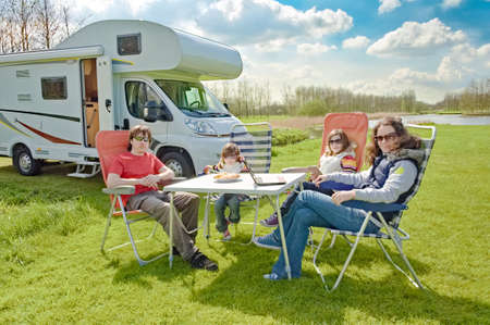 Family vacation, RV travel with kids, happy parents with children have fun on holiday trip in motorhome, camper exterior