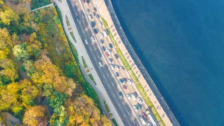 Aerial top view of road automobile traffic jam of many cars from above, Dnipro river and Kyiv autumn cityscape, city transportation conceptの写真素材