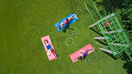Family fitness and sport outdoors, group of active girls doing workout in park, women exercising...