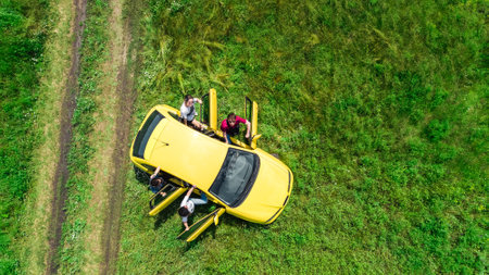 Family and friends car travel on vacation, happy parents and kids have fun in holiday trip, aerial drone view of car and people from aboveの写真素材