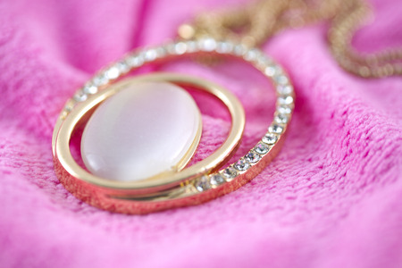 Necklace Diamond gold on fabric pink.の写真素材