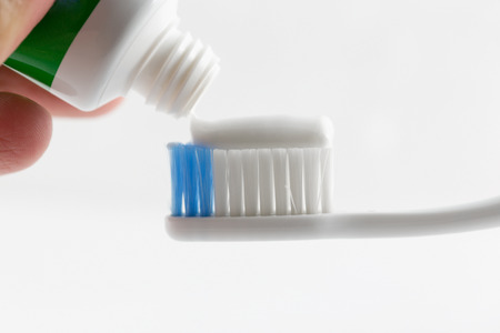 Hand press Toothpaste on tooth brush.の写真素材
