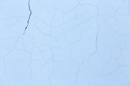 Concrete cement wall with crack blue background.の写真素材