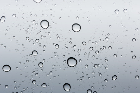 Water drop gradient on glass mirror background.の写真素材