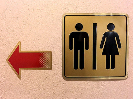 Sign Toilet Women and Men turn left.の写真素材