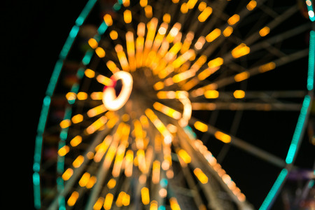 Blurry, Ferris wheel with outdoor long exposure at night.の写真素材