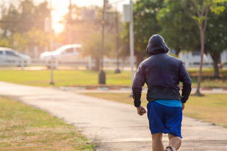Young man running in the park.の写真素材