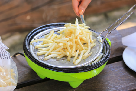 French fries cooking on deep fryer.の写真素材