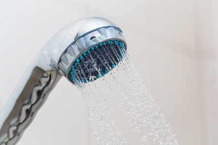 Shower with water steam in the bathroom.の写真素材