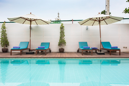 Beach chairs and swimming pool in the resort holiday.のeditorial素材