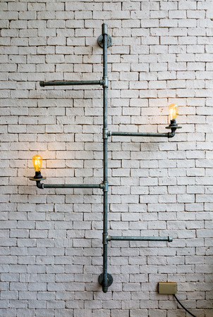 Home decoration pipes light bulb with white wallの写真素材
