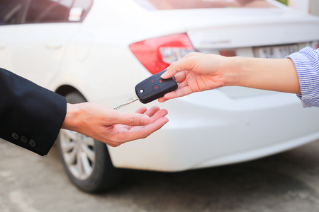 Business hand giving a key for buyer or rental car.の写真素材
