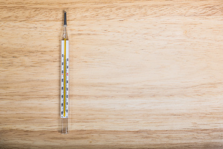 Thermometer on wooden background : blank text.の写真素材