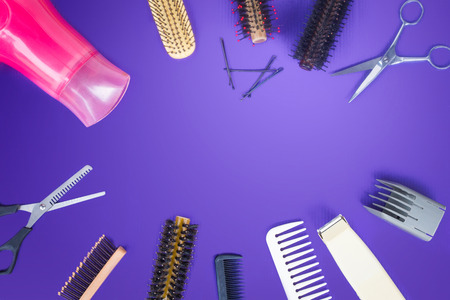 Hairdresser set with comb on top of purple background.の写真素材
