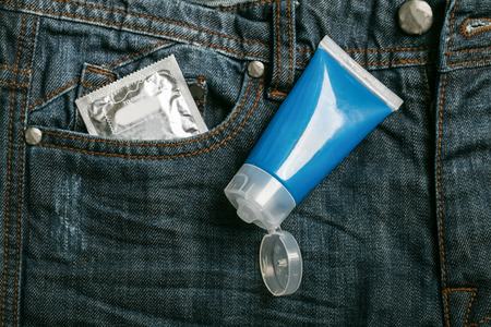 Condom package in back pocket jeans. Protect HIV and for world AIDS day
