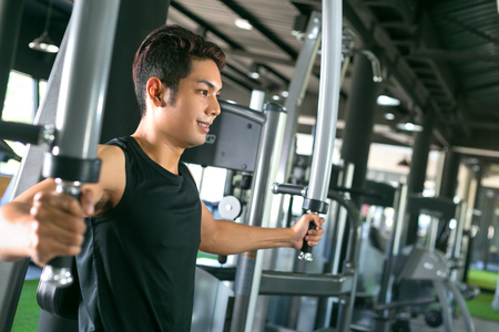Young man bodybuilder training in the gym: chest.の写真素材