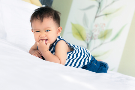 Morning awakening little child boy happiness in bed.の写真素材